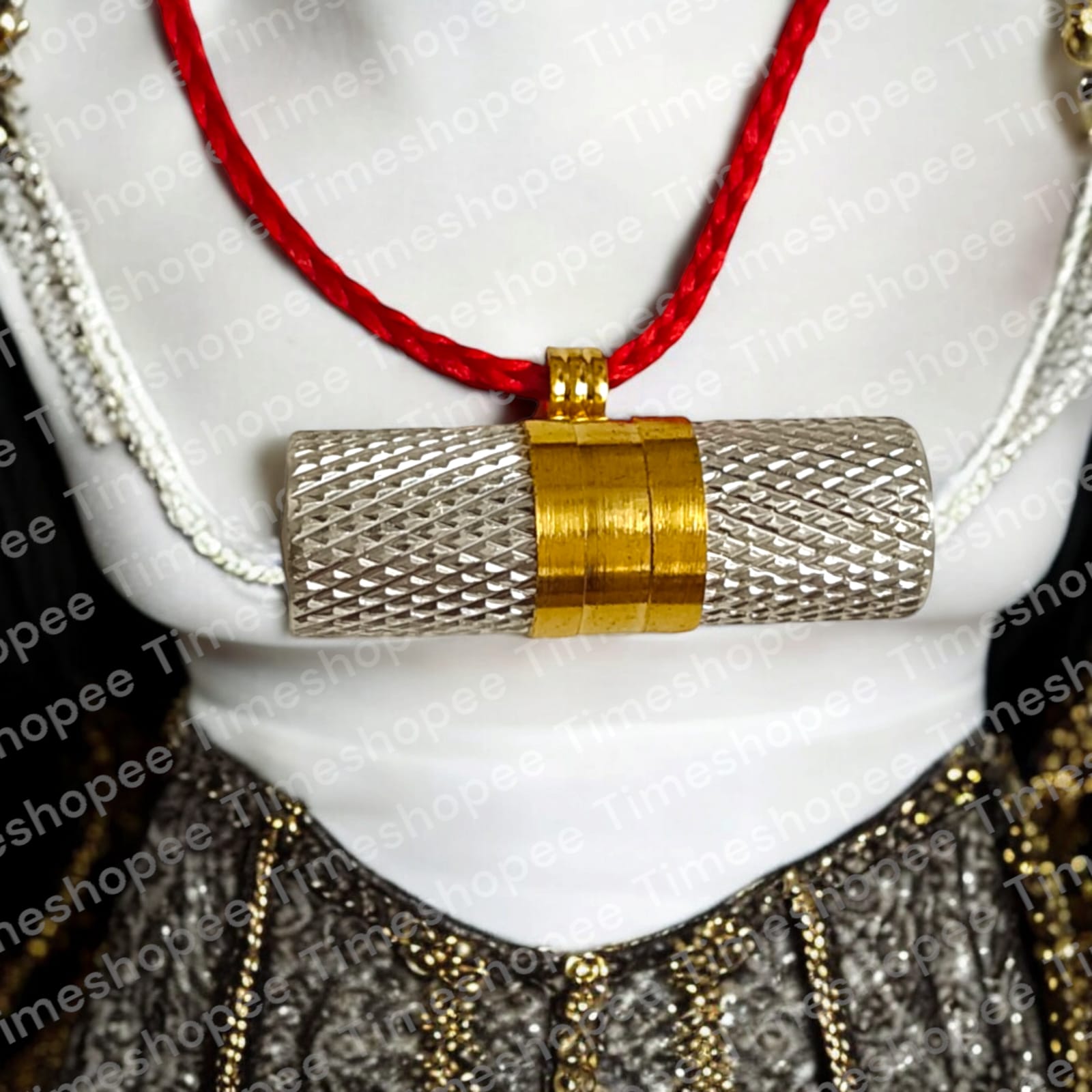Silver and golden taweezes with Bhojpatra sheet, displayed on a neutral background