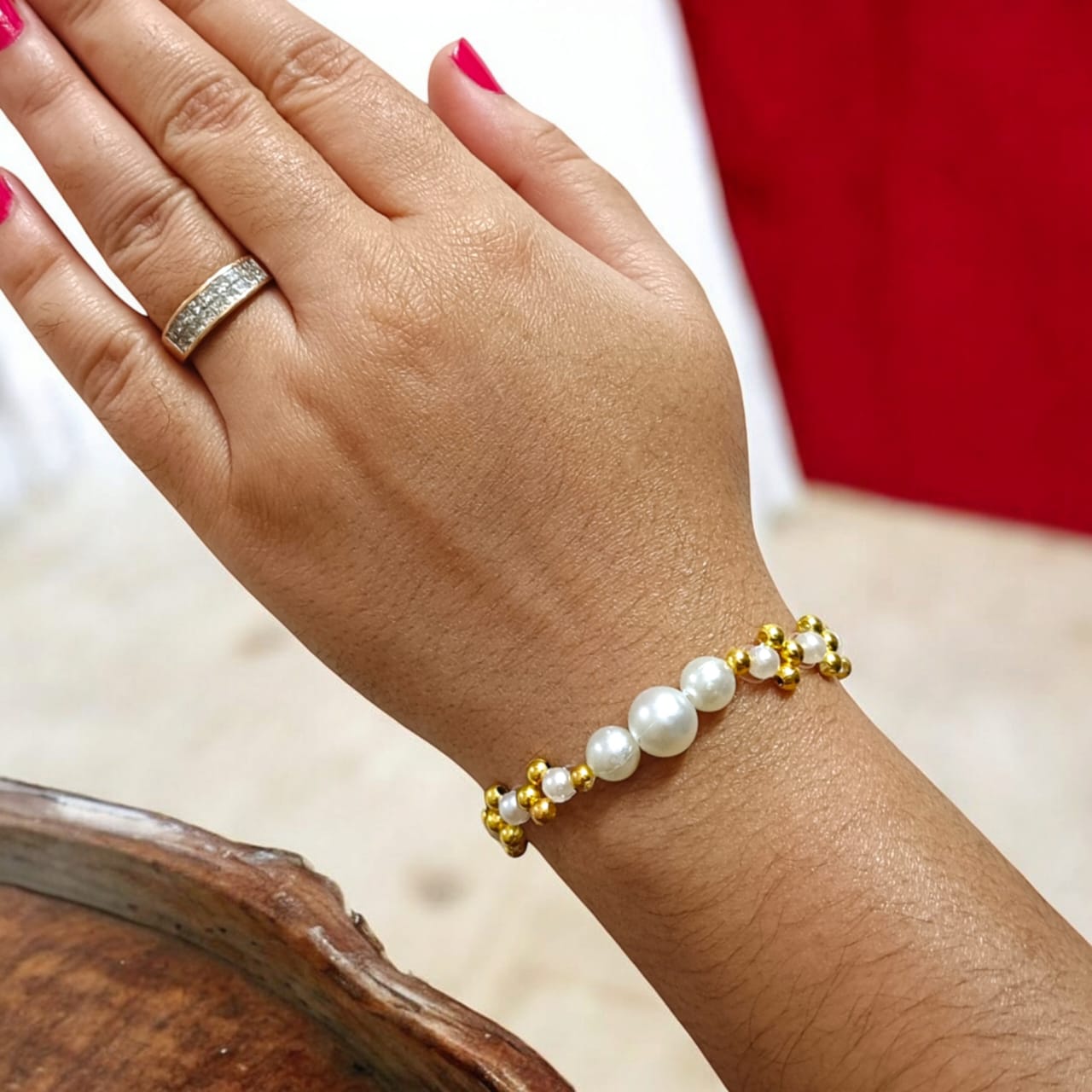 White and golden pearl bead bracelet with a lobster clasp, designed for girls and women, perfect for matching with golden and white outfits.