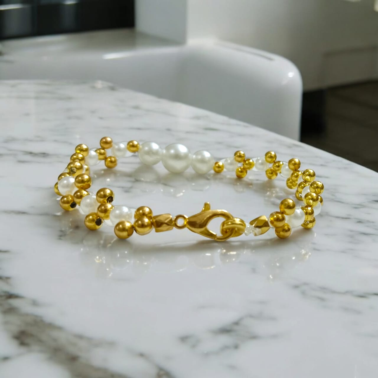 White and golden pearl bead bracelet with a lobster clasp, designed for girls and women, perfect for matching with golden and white outfits.