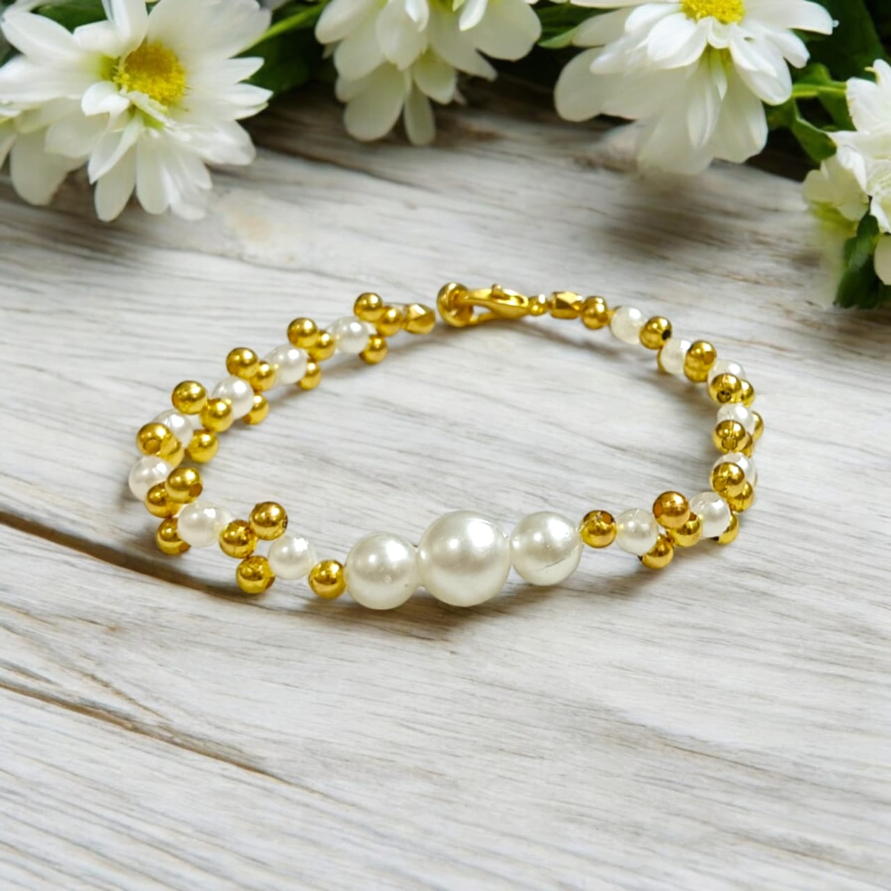 White and golden pearl bead bracelet with a lobster clasp, designed for girls and women, perfect for matching with golden and white outfits.
