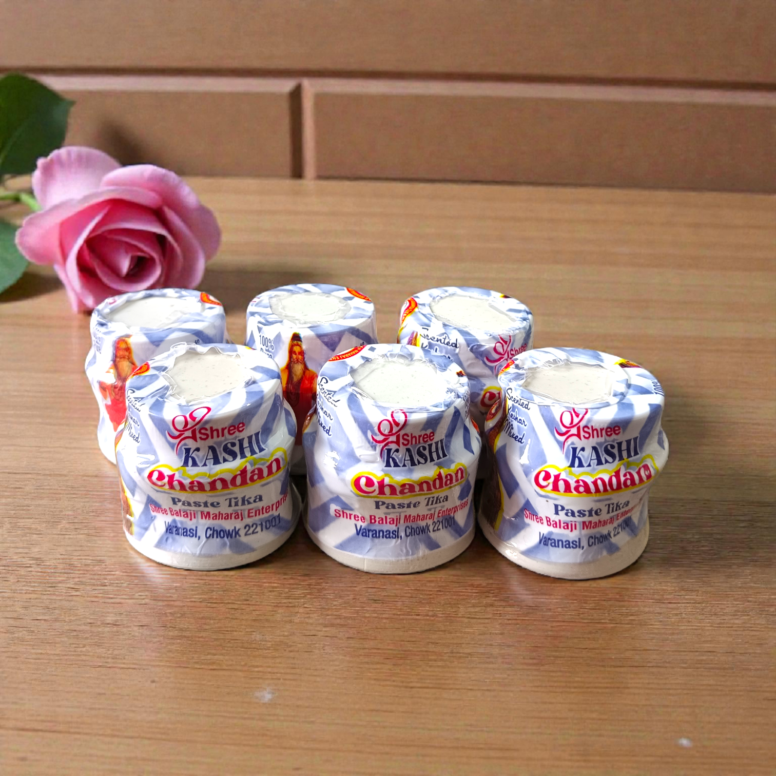 White chandan paste container used for tilak, puja, and religious rituals