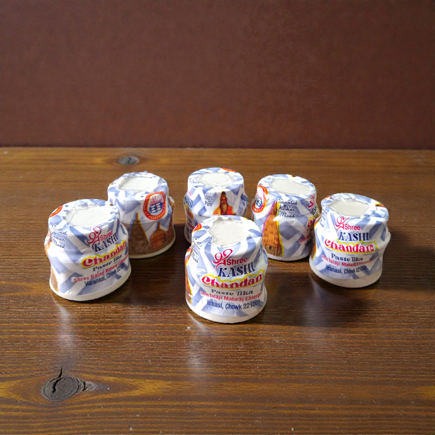 White chandan paste container used for tilak, puja, and religious rituals