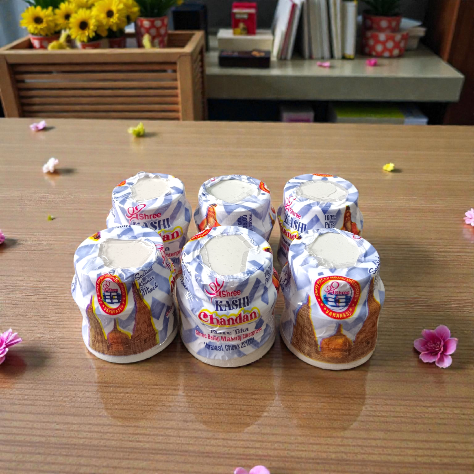 White chandan paste container used for tilak, puja, and religious rituals