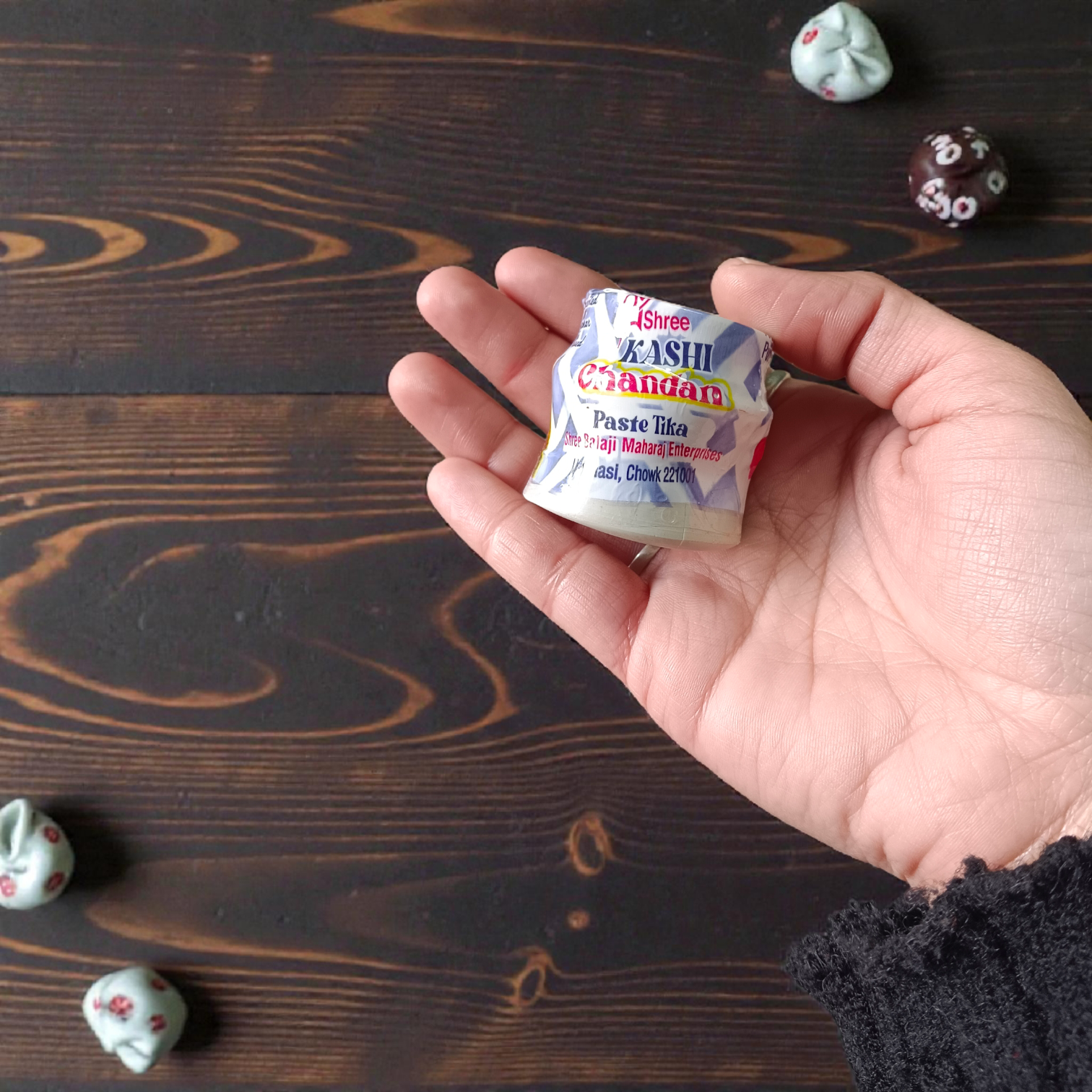 White chandan paste container used for tilak, puja, and religious rituals