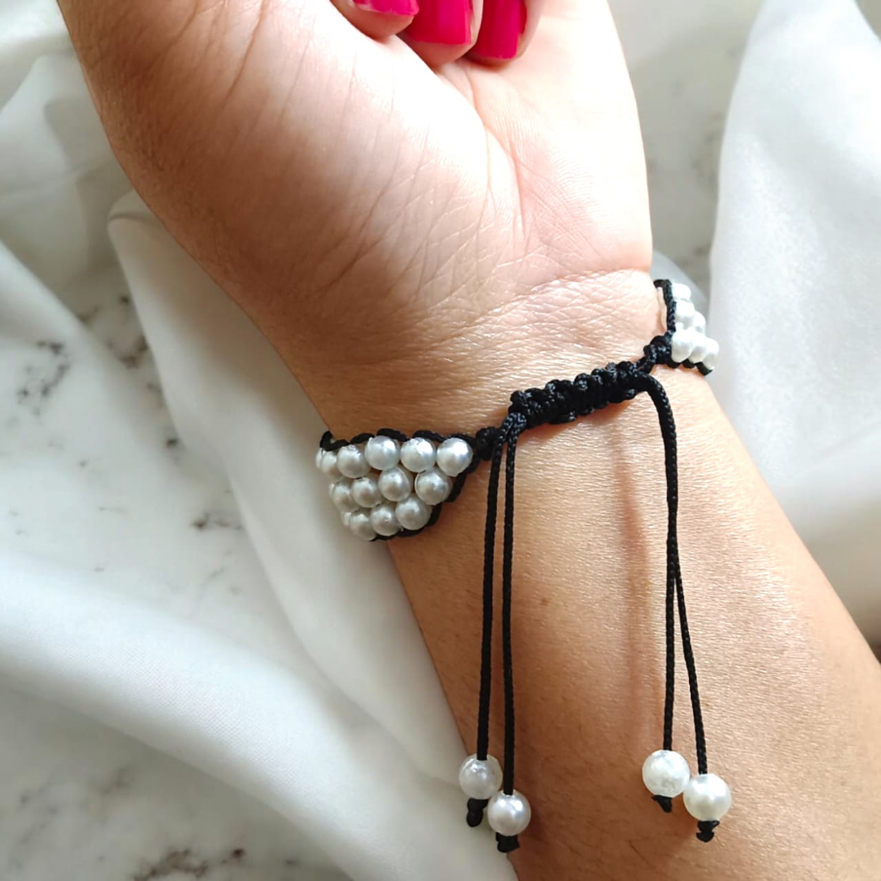 White pearl bracelet with adjustable sliding knot clasp, designed for girls and women, perfect for adding elegance to any outfit.