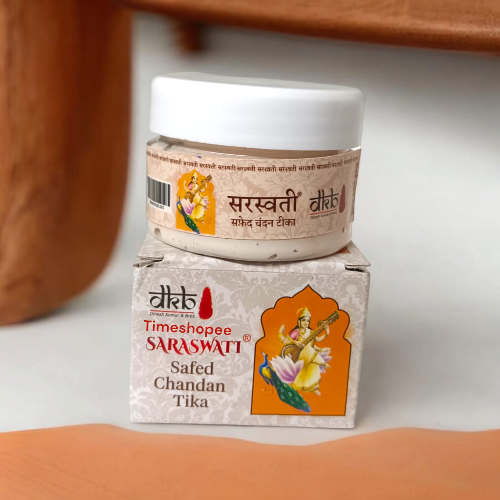 White sandalwood paste in a container, used for tilak, puja, and daily religious rituals, with a long-lasting fragrance.
