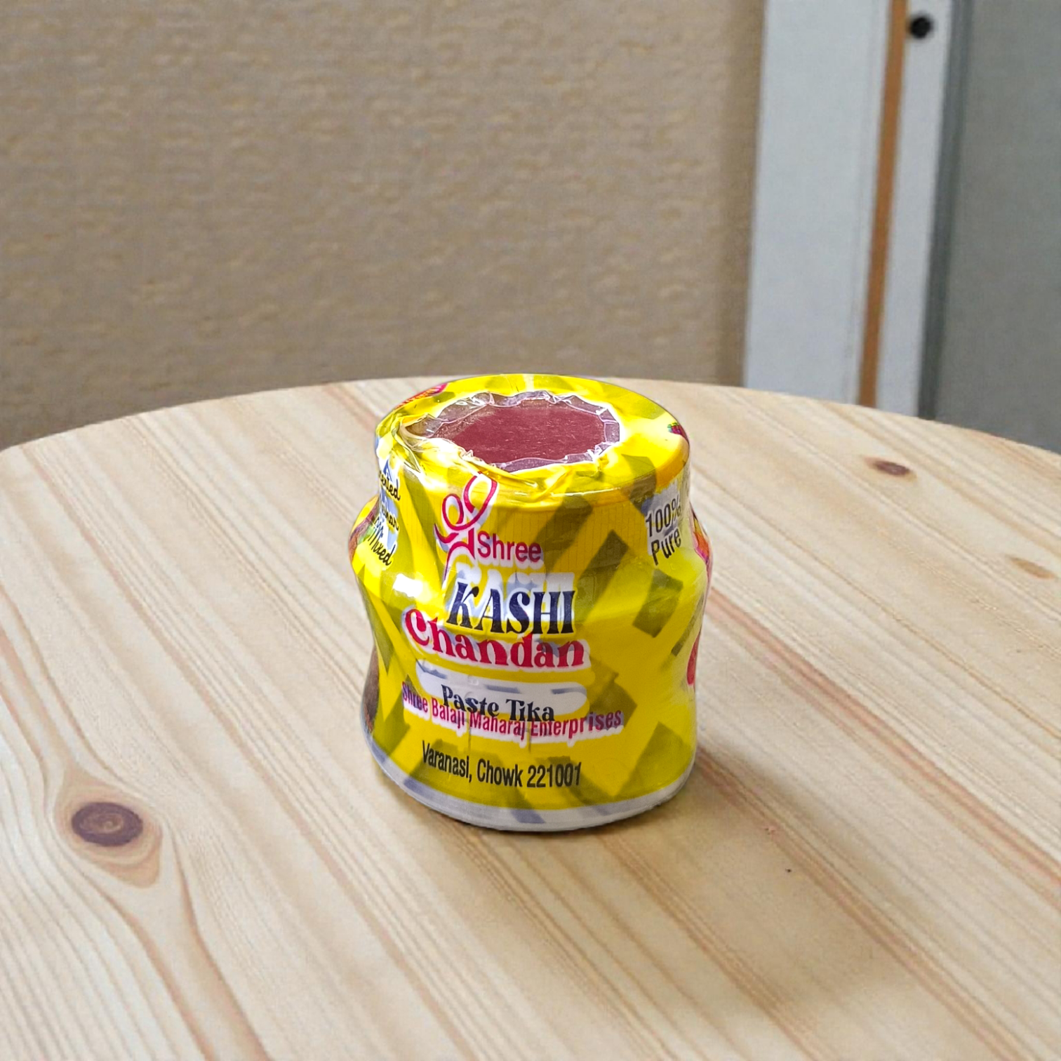 Yellow, red, and white chandan paste containers used for tilak and puja