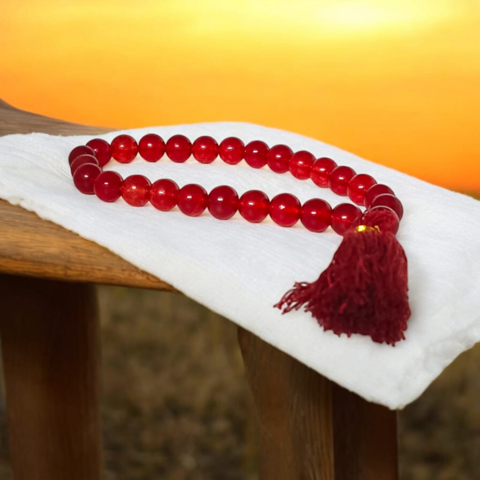 A 27+1 bead red agate mala, each bead measuring 8mm, shown with its lab certification. Ideal for meditation, wearing, or keeping in cars and offices.
