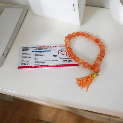 A Hessonite (Gomed) Mala with 27+1 lab-certified deep red gemstone beads, each 8MM in size, designed for meditation, focus, and astrological benefits, ideal for travel, office, and car.