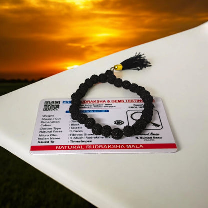 A 27+1 bead Black Rudraksha Mala with 7MM-sized beads, elegantly designed for spiritual use. Suitable for car, office, or travel, the lab-certified beads offer protection and a calming influence.