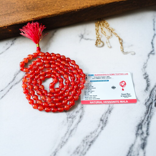 A Hessonite (Gomed) Mala with 27+1 lab-certified deep red gemstone beads, each 8MM in size, designed for meditation, focus, and astrological benefits, ideal for travel, office, and car.