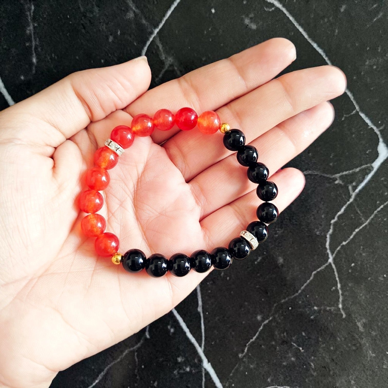 A Hessonite and Black Agate Bracelet with 8MM lab-certified beads, featuring a stretchable design for comfort and spiritual protection