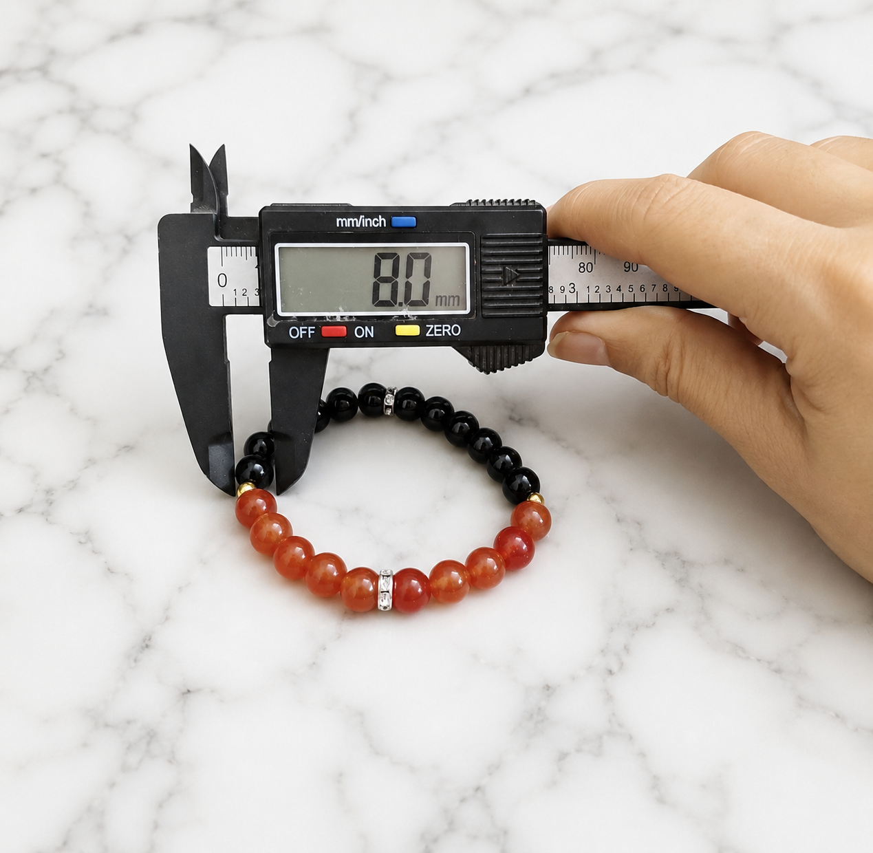 A Hessonite and Black Agate Bracelet with 8MM lab-certified beads, featuring a stretchable design for comfort and spiritual protection