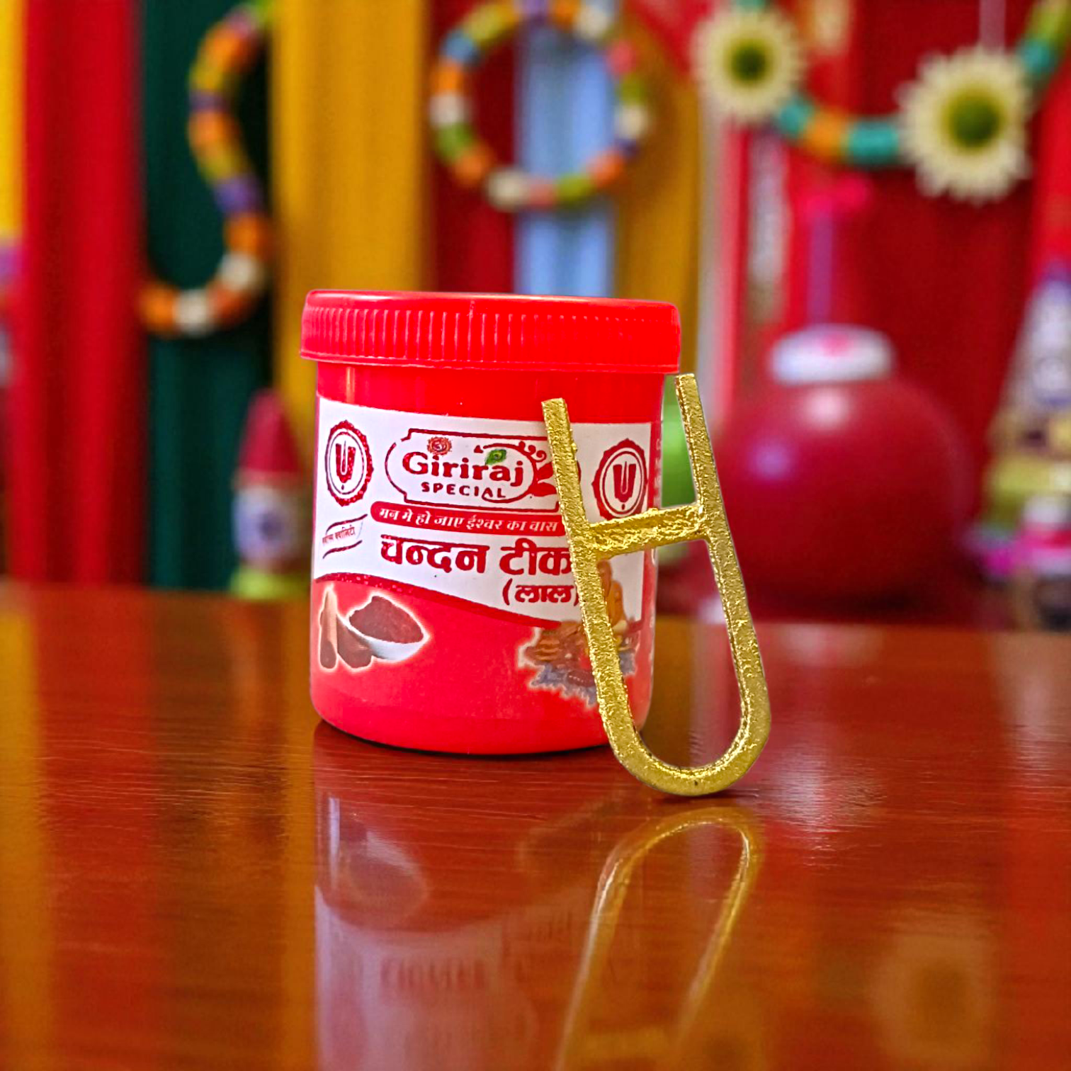 A Vishnu Tilak Stamp made for forehead tilak application, placed on a puja setup with Chandan and Kumkum nearby