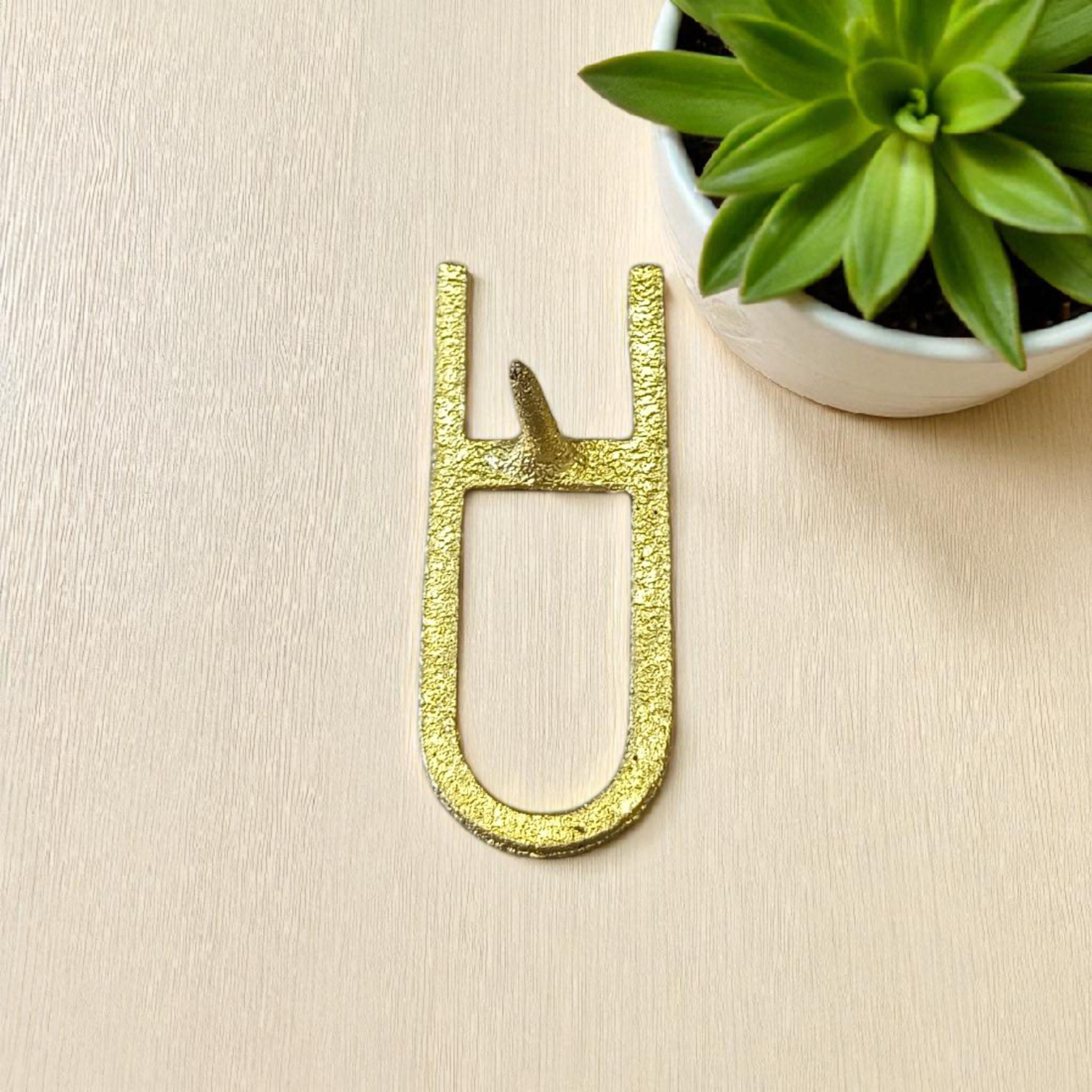 A Vishnu Tilak Stamp made for forehead tilak application, placed on a puja setup with Chandan and Kumkum nearby