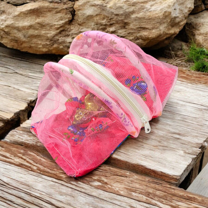 A beautiful 7X10 inch comfortable bed with a mosquito net and three pillows, designed for Laddu Gopal or Radha Rani, available in five vibrant colors for temple use.