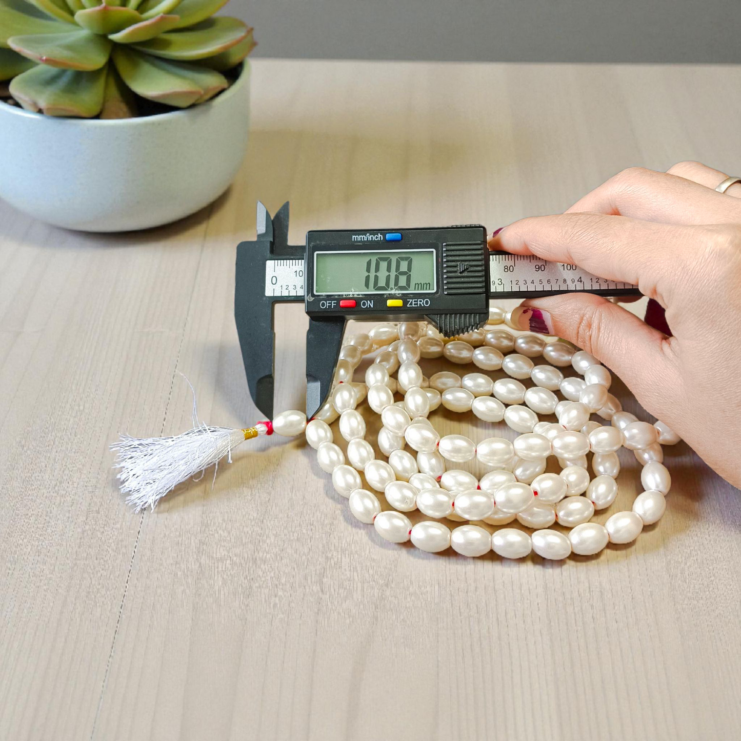 A beautiful Natural Pearl Mala with 108+1 white round beads (10-11mm), handcrafted and lab-certified, ideal for meditation and Japa rituals