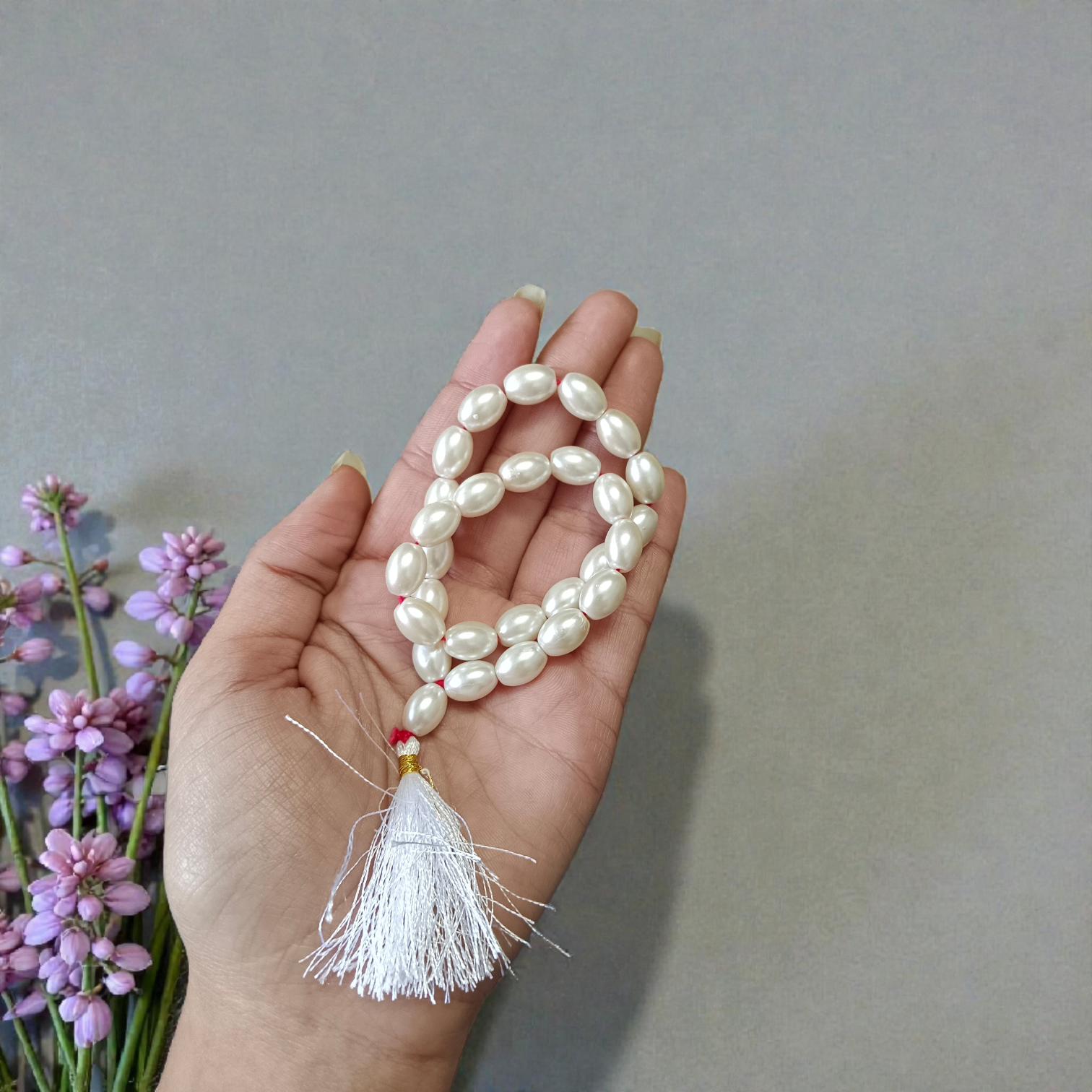 A beautiful Natural Pearl Mala with 108+1 white round beads (10-11mm), handcrafted and lab-certified, ideal for meditation and Japa rituals