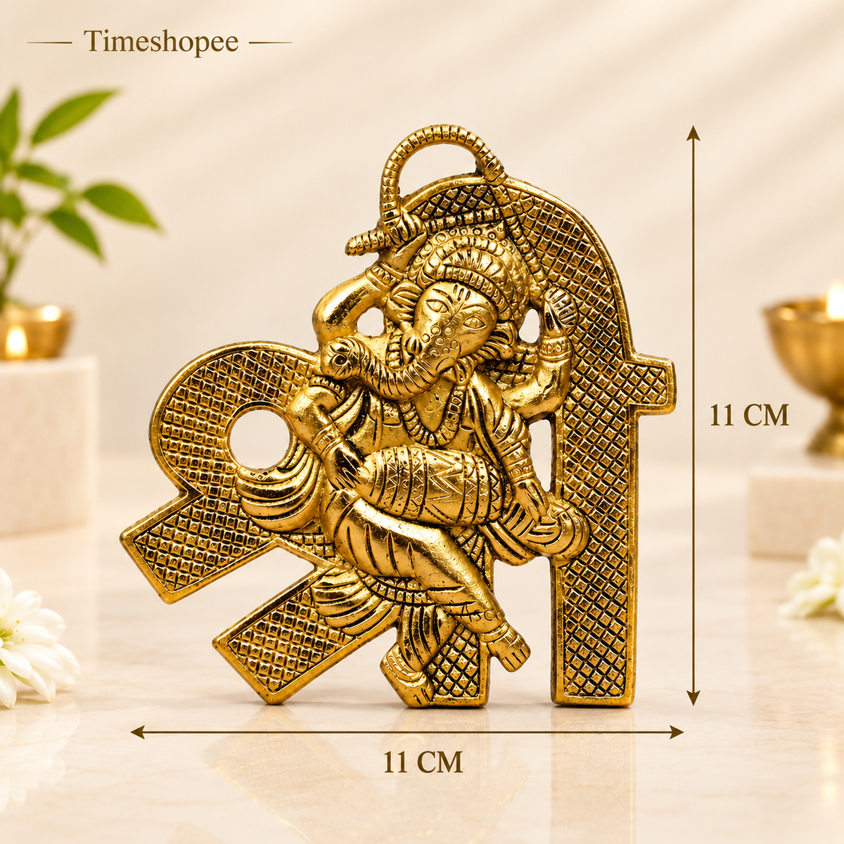 A beautifully crafted brass wall hanging of Shri Ganesh, measuring 11X11 CM, suitable for decorating temple walls, office spaces, and home doors.