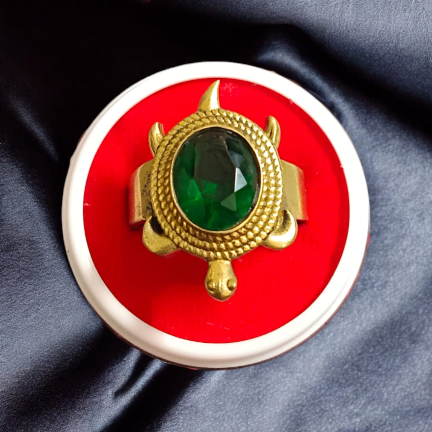 A close-up of the Kachua Panna Ring, featuring a green Panna gemstone set in a tortoise-shaped design made from Ashtdhatu. The ring is adjustable and suitable for men and women.