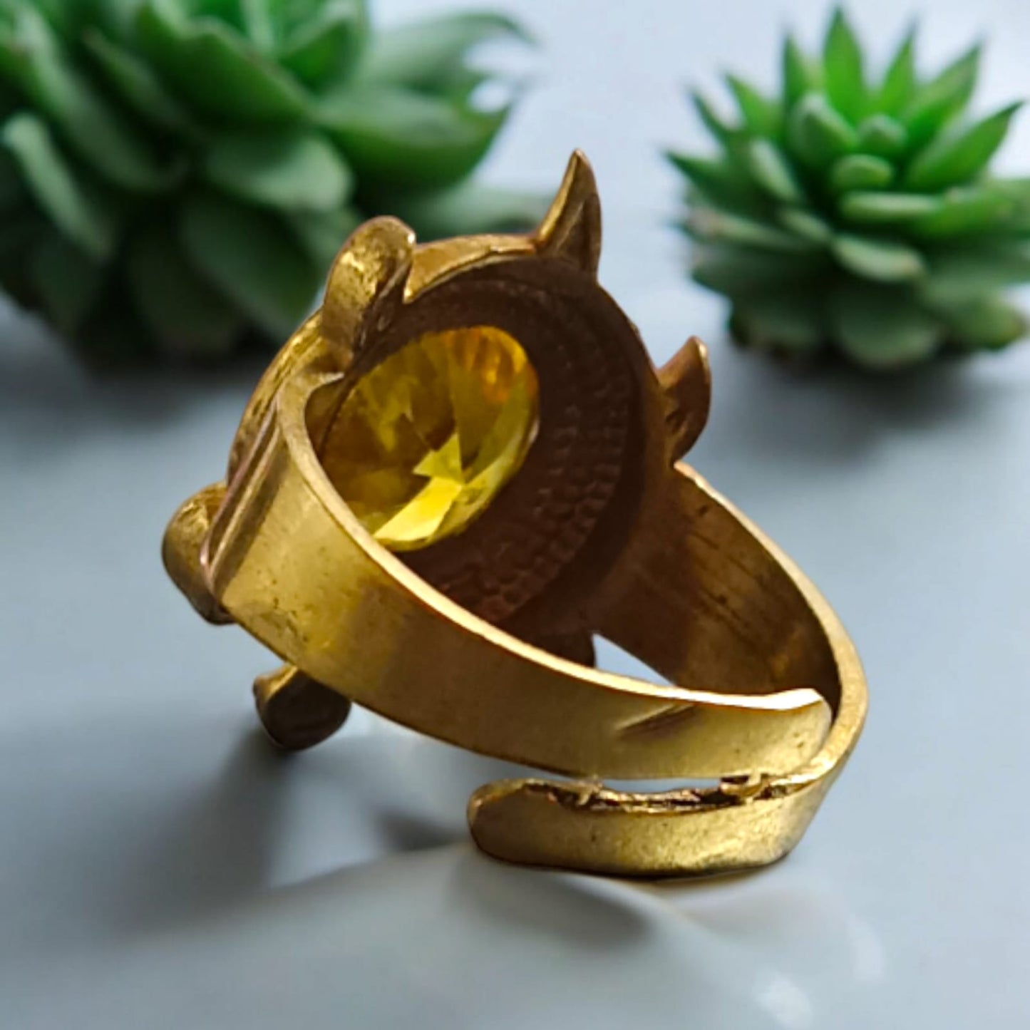 A close-up of the Kachua Pukhraj Ring, featuring a bright yellow Pukhraj (Yellow Sapphire) gemstone set in a tortoise-shaped design made from Ashtdhatu. The ring is adjustable and suitable for both men and women.
