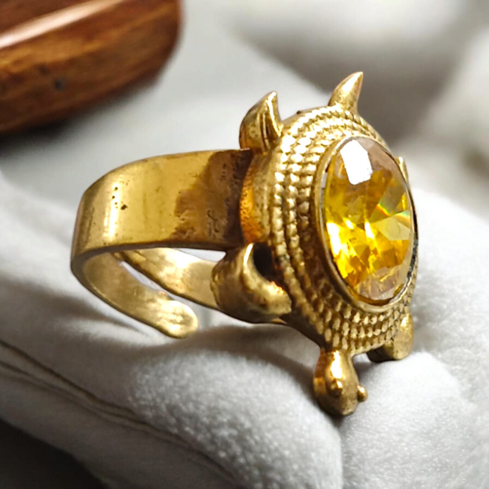 A close-up of the Kachua Pukhraj Ring, featuring a bright yellow Pukhraj (Yellow Sapphire) gemstone set in a tortoise-shaped design made from Ashtdhatu. The ring is adjustable and suitable for both men and women.