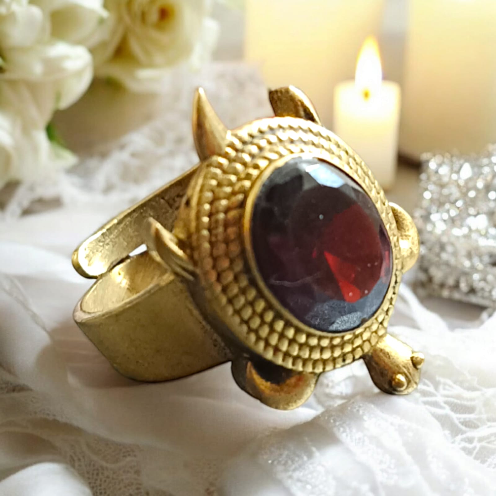 A close-up view of the Kachua Manik Ring, featuring a vibrant red Manik (Ruby) gemstone set in a tortoise-shaped design made from Ashtdhatu. The ring is adjustable and suitable for both men and women.