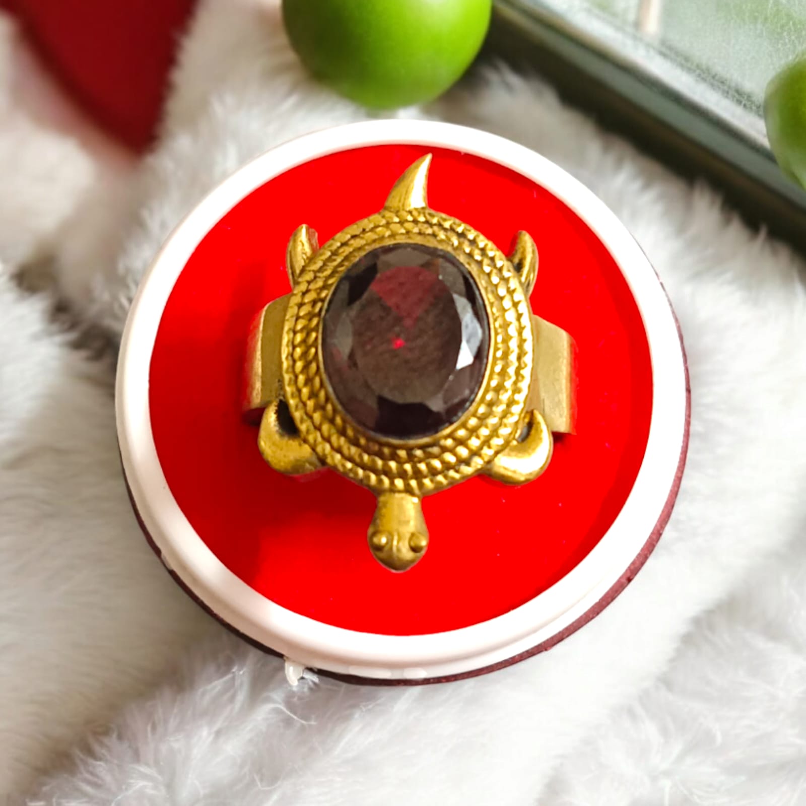 A close-up view of the Kachua Manik Ring, featuring a vibrant red Manik (Ruby) gemstone set in a tortoise-shaped design made from Ashtdhatu. The ring is adjustable and suitable for both men and women.