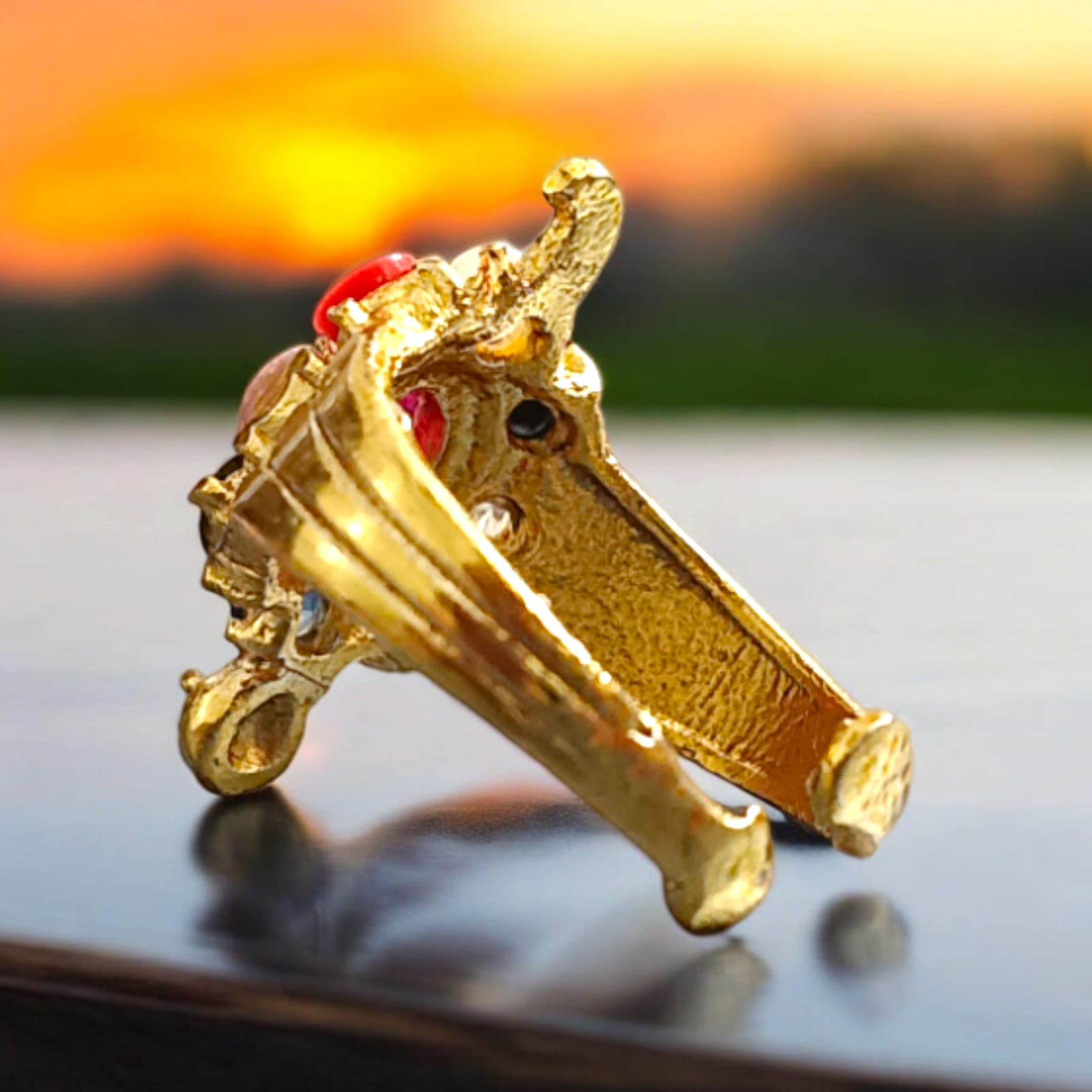 A close-up view of the Navratna Kachua Ring, featuring an array of nine Navratna gemstones set in a gold-plated tortoise-shaped design. The ring is adjustable and suitable for both men and women.