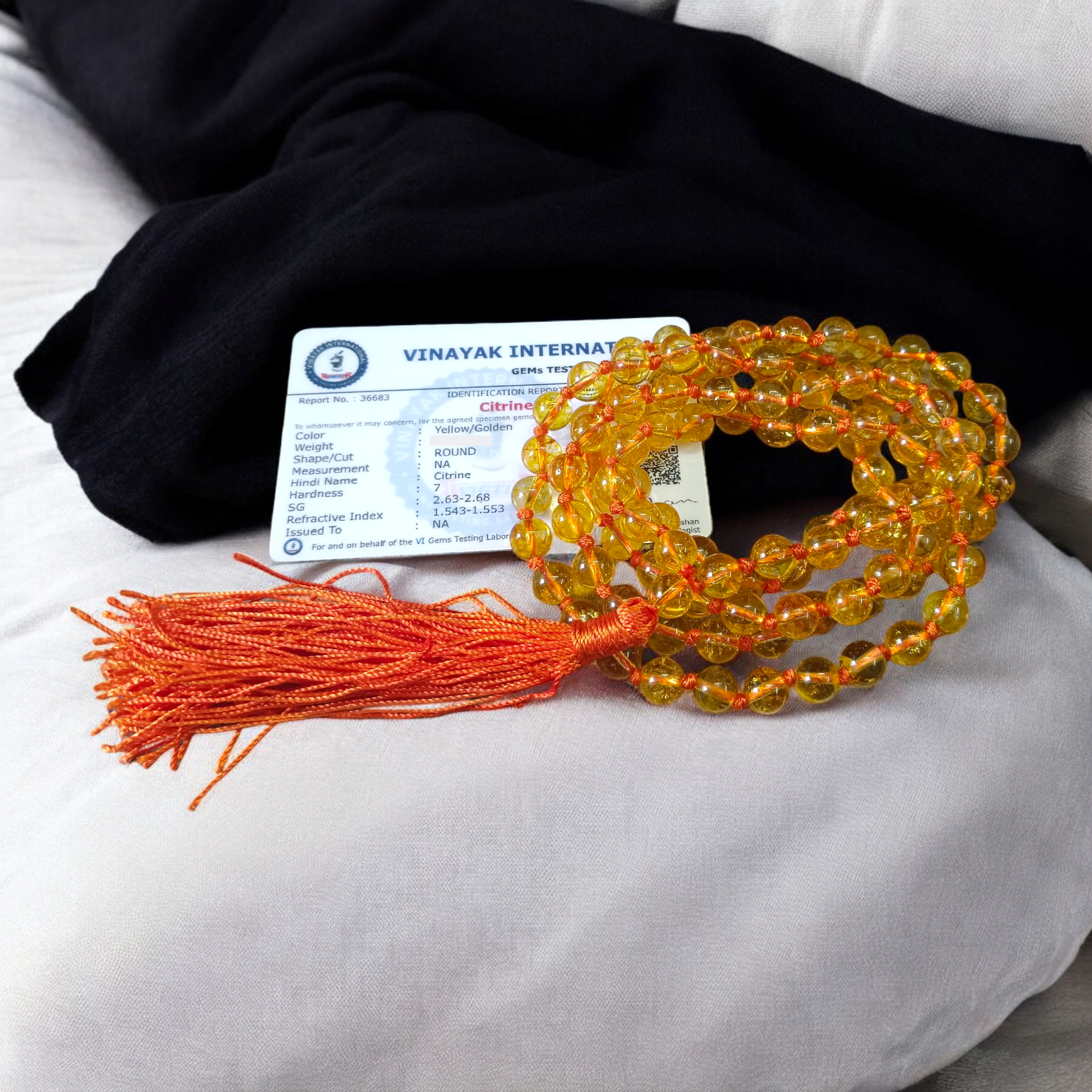 A handcrafted Citrine Mala made of 108+1 golden-yellow 8mm beads, used for meditation, energy healing, and Japa, displayed on a wooden background