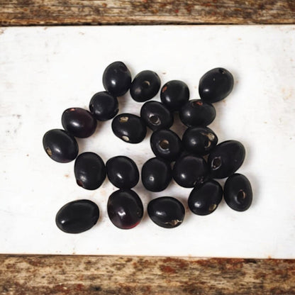 A set of 21 lab-certified Gunja seeds in red, white, and black, featuring loose beads ideal for spiritual use, crafting, or decoration.