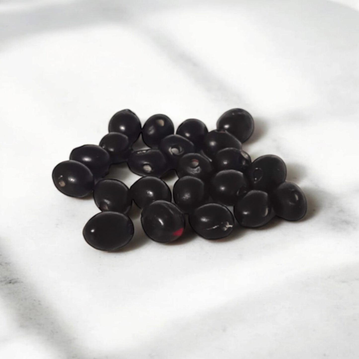 A set of 21 lab-certified Gunja seeds in red, white, and black, featuring loose beads ideal for spiritual use, crafting, or decoration.