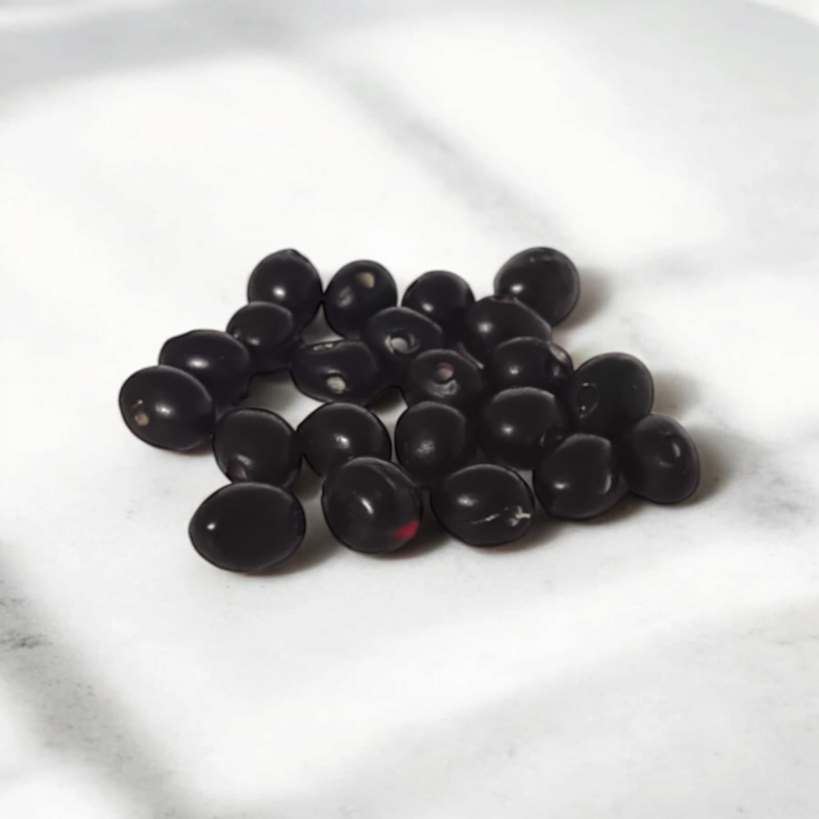 A set of 21 lab-certified Gunja seeds in red, white, and black, featuring loose beads ideal for spiritual use, crafting, or decoration.