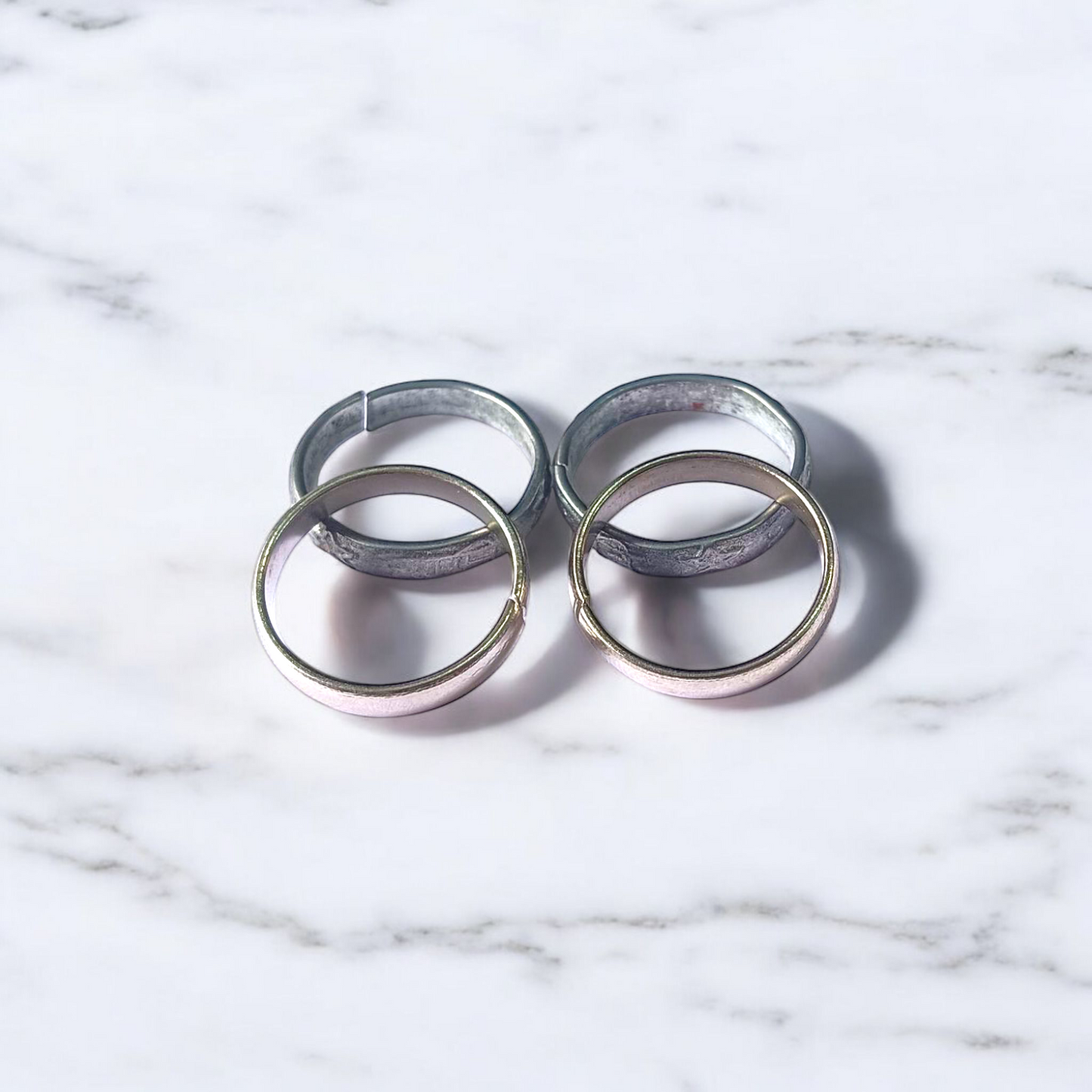 A set of four Ghode Ki Naal ka Challa rings made from black horse shoe nails, each ring designed to mitigate the negative effects of Saturn (Shani). The rings are shown in a close-up view to highlight their craftsmanship and material