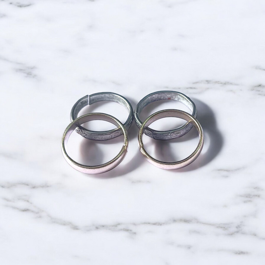 A set of four Ghode Ki Naal ka Challa rings made from black horse shoe nails, each ring designed to mitigate the negative effects of Saturn (Shani). The rings are shown in a close-up view to highlight their craftsmanship and material