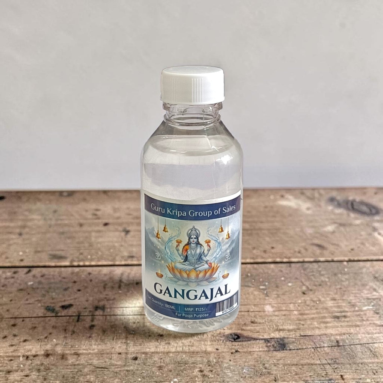 A set of two 100g bottles of Pure Gangajal Holy Water placed side by side, labeled for pooja and spiritual use
