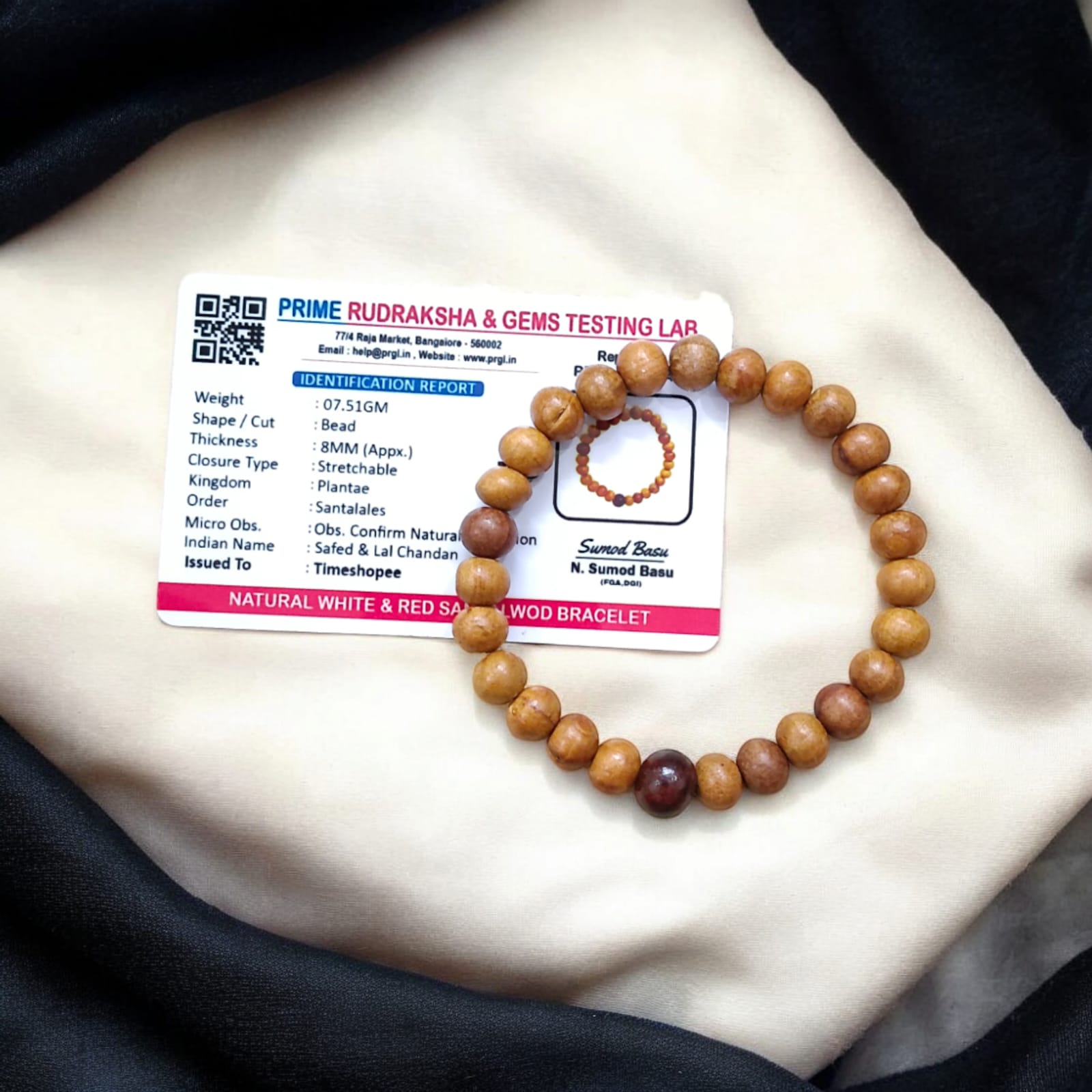 A beautiful Red & White Sandalwood Bracelet with 8MM lab-certified beads, showcasing its elegant design and spiritual significance.