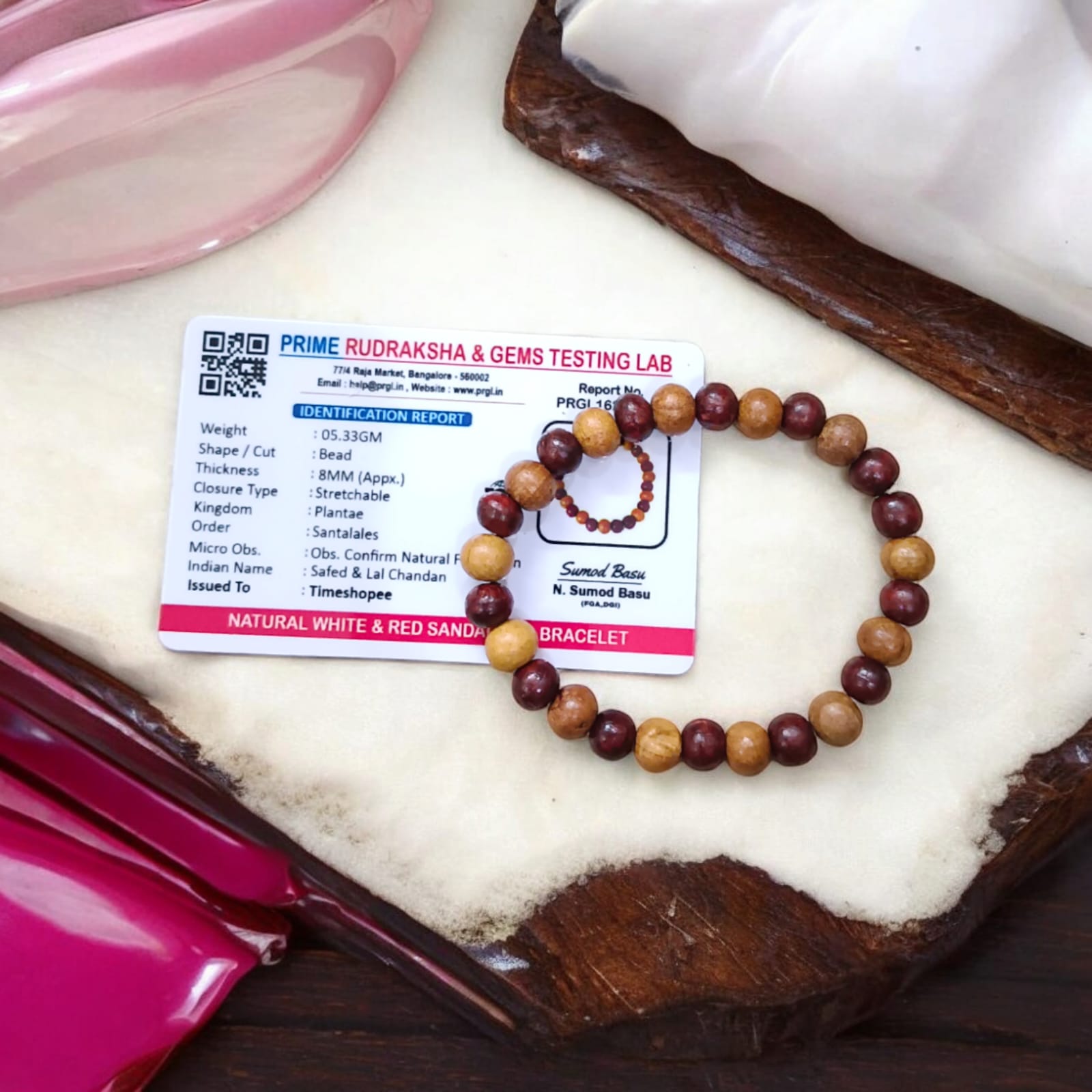 A beautiful Red & White Sandalwood Bracelet with 8MM lab-certified beads, showcasing its elegant design and spiritual significance.