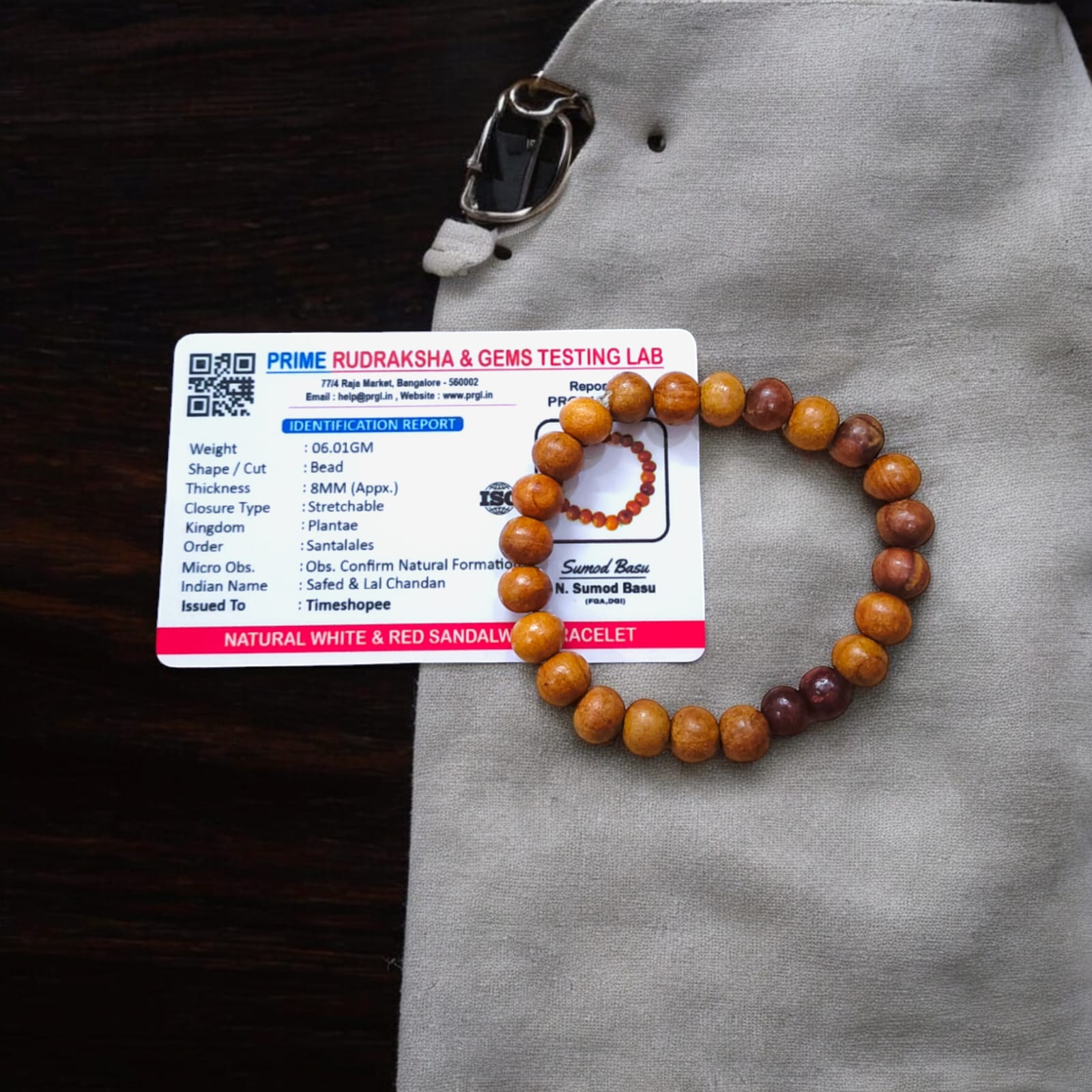 A beautiful Red & White Sandalwood Bracelet with 8MM lab-certified beads, showcasing its elegant design and spiritual significance.