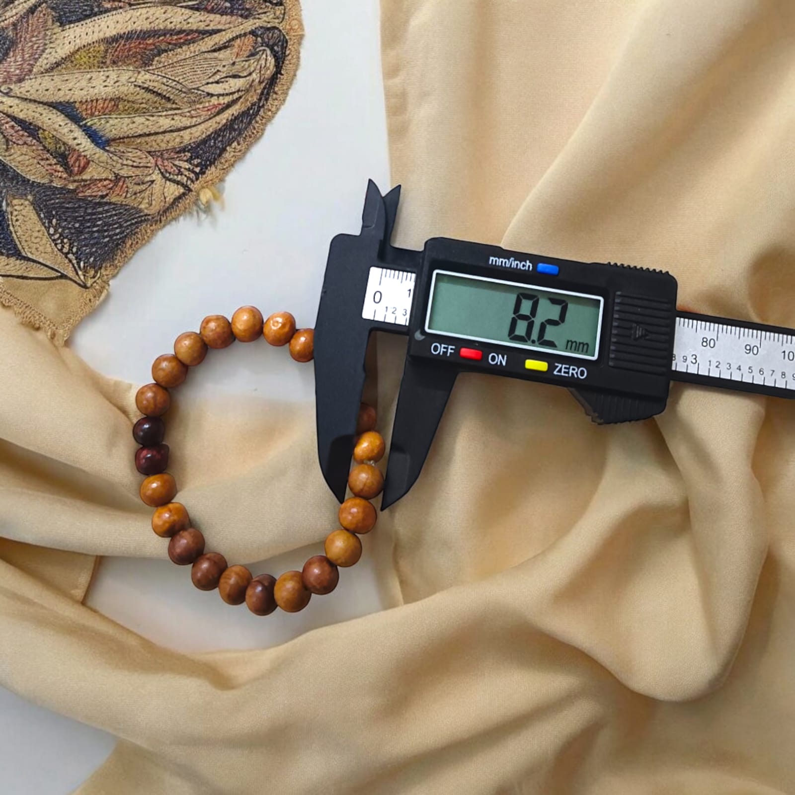 A beautiful Red & White Sandalwood Bracelet with 8MM lab-certified beads, showcasing its elegant design and spiritual significance.