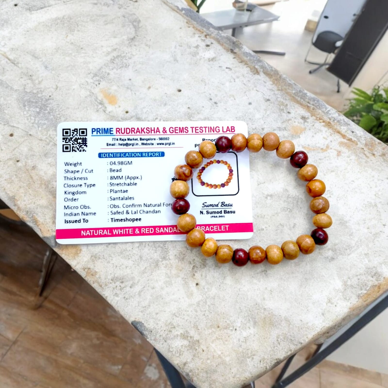 A beautiful Red & White Sandalwood Bracelet with 8MM lab-certified beads, showcasing its elegant design and spiritual significance.