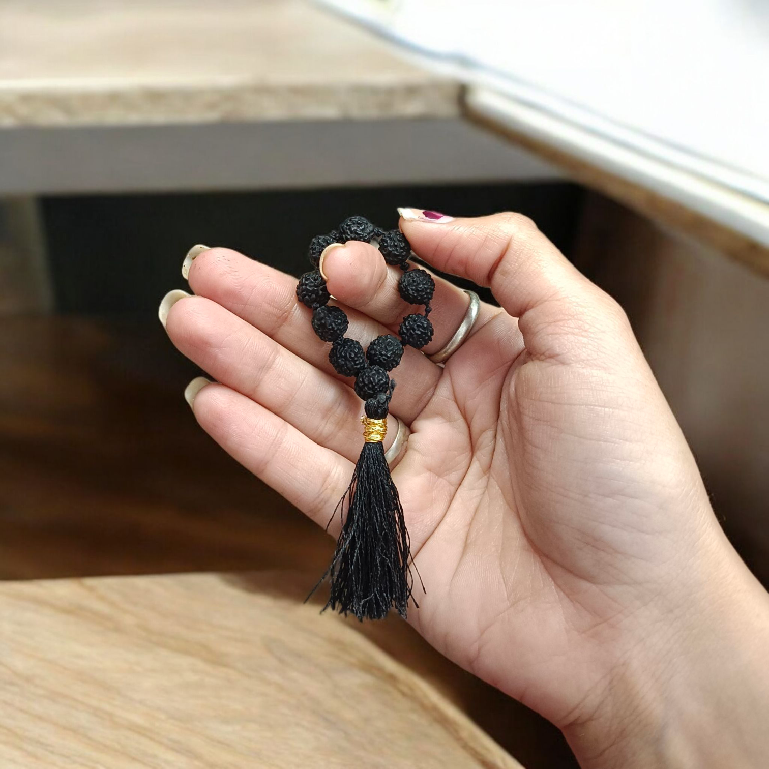 Black 5 Mukhi Rudraksha Mala with 108+1 natural beads, used for meditation and mantra chanting, displayed on a white background