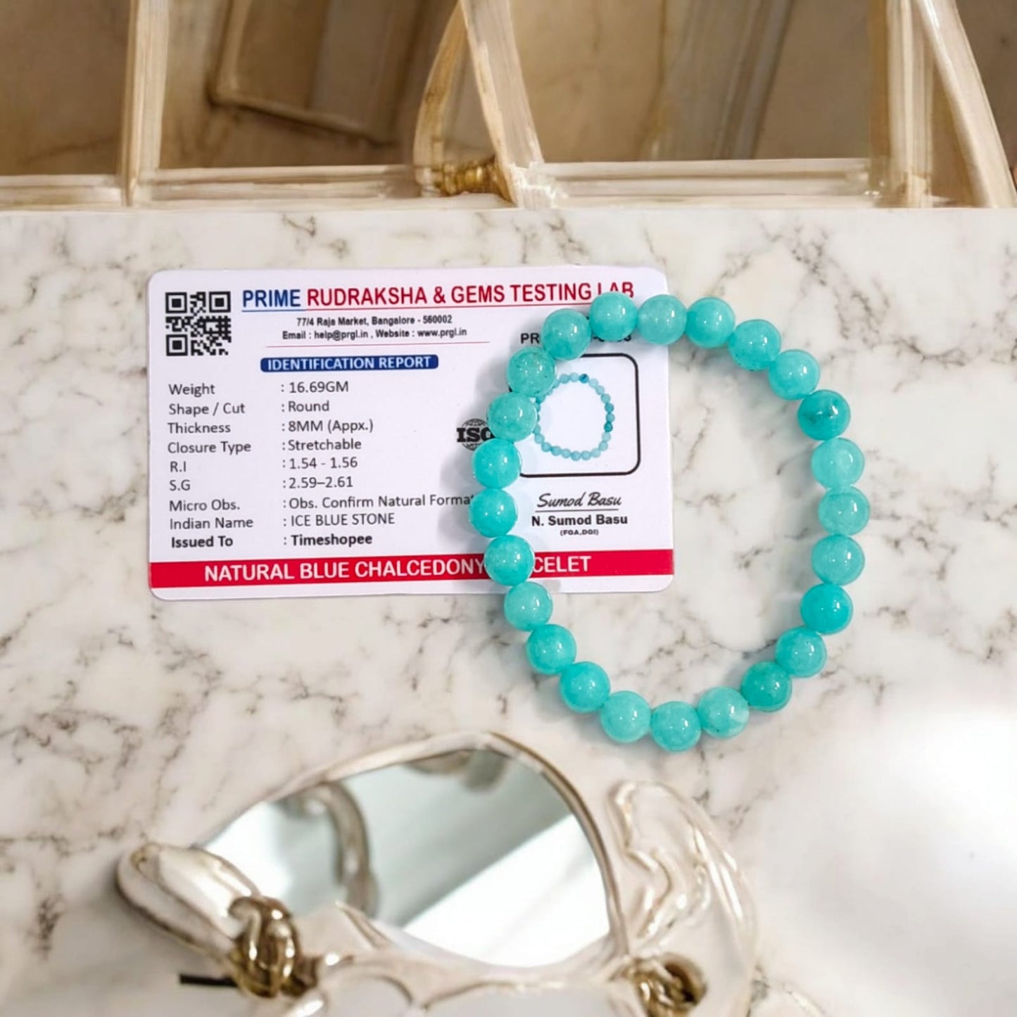 Blue Chalcedony Bracelet with lab certification, showcasing the stretchable design and soothing blue crystal.