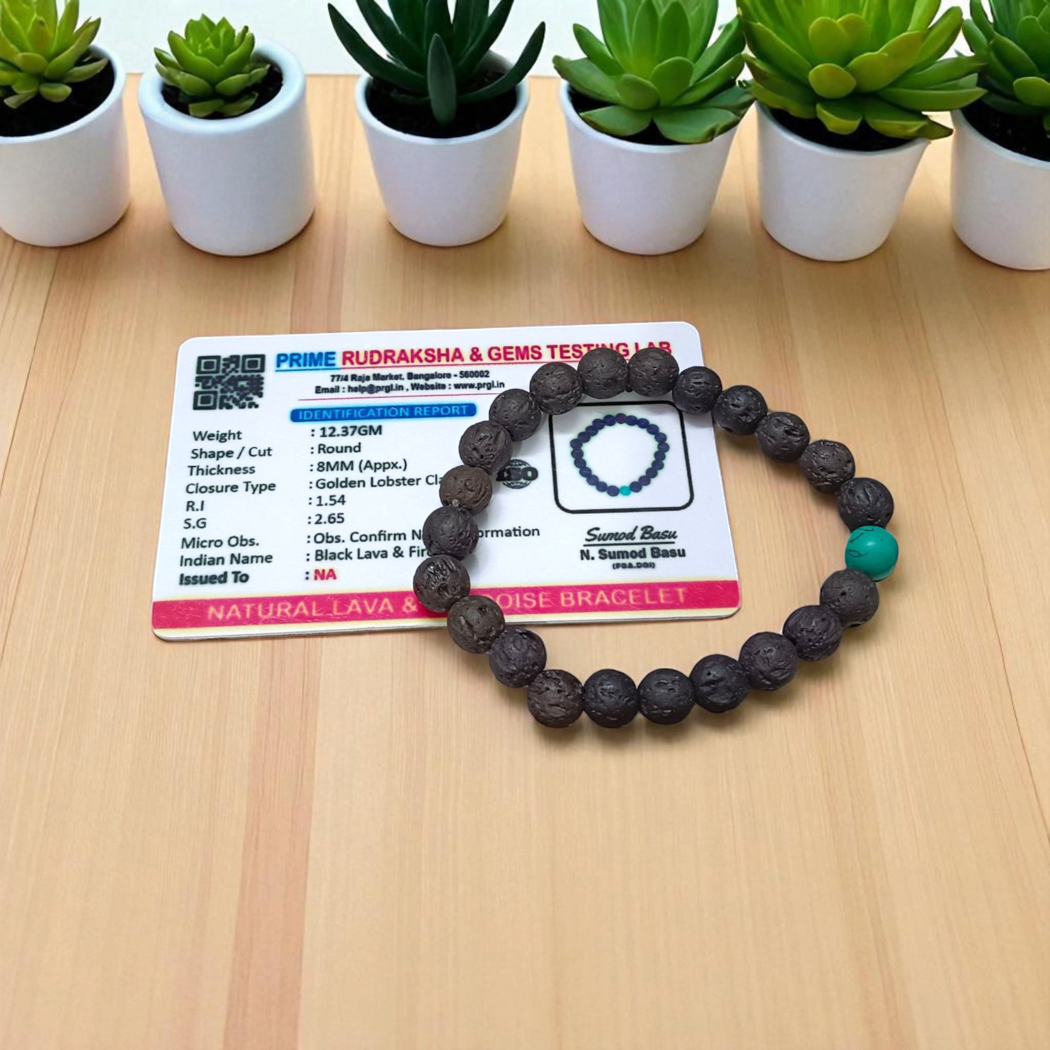 Bracelet made with 8mm black lava stones and turquoise (Firoza) beads, arranged on stretchable thread and placed on a soft neutral background