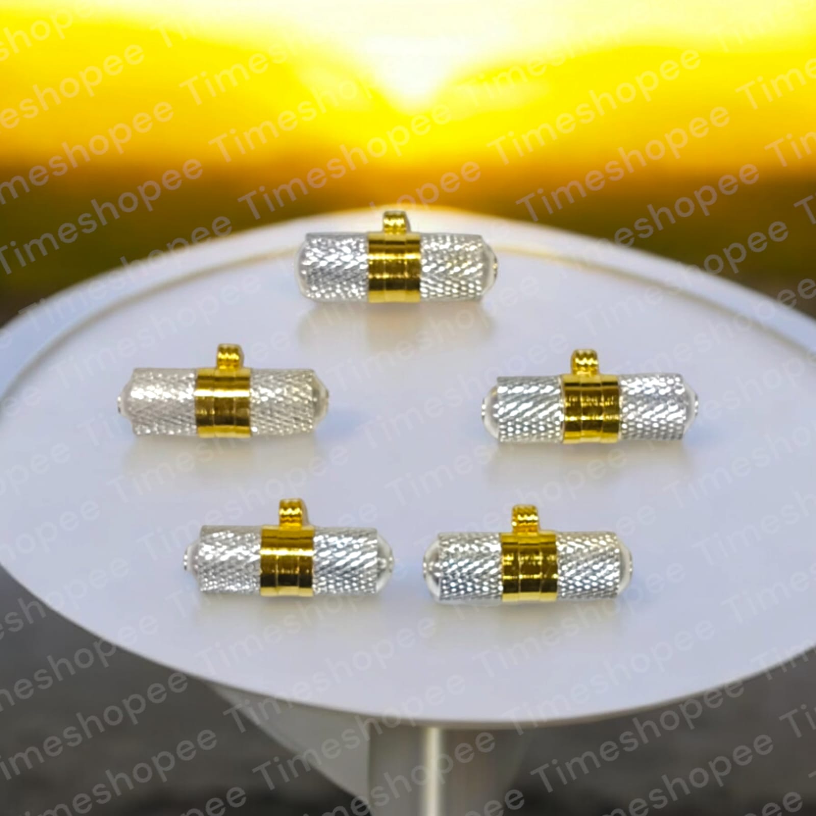 Brass and silver taweezes with Bhojpatra sheet, displayed elegantly on a neutral background