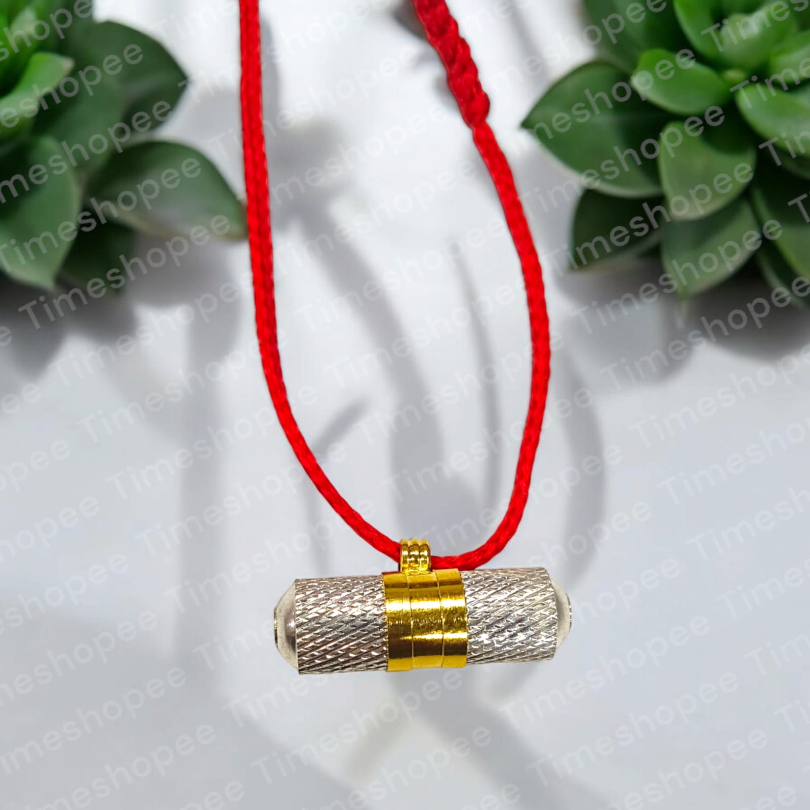 Brass and silver taweezes with Bhojpatra sheet, displayed elegantly on a neutral background