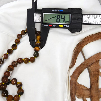 High-quality image of Tiger Eye Mala with natural golden-brown stone beads arranged in a traditional mala style