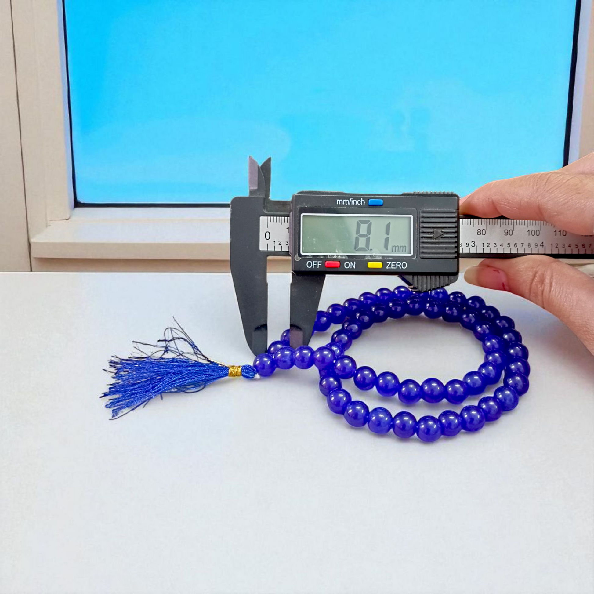 Image of Blue Agate Mala featuring 54+1 polished 8mm blue beads, neatly strung for mantra chanting, meditation, and spiritual growth