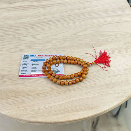 Image of Safed Chandan Mala with 54+1 smooth 8mm white sandalwood beads, naturally fragrant, arranged for meditation, chanting, and spiritual peace
