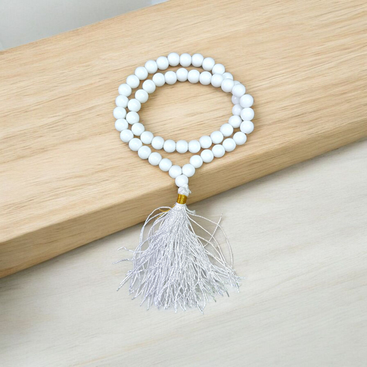 Image of White Agate Mala with 54+1 smooth 8mm Safed Hakik beads, neatly arranged for jaap, meditation, and emotional balance, on a soft spiritual background